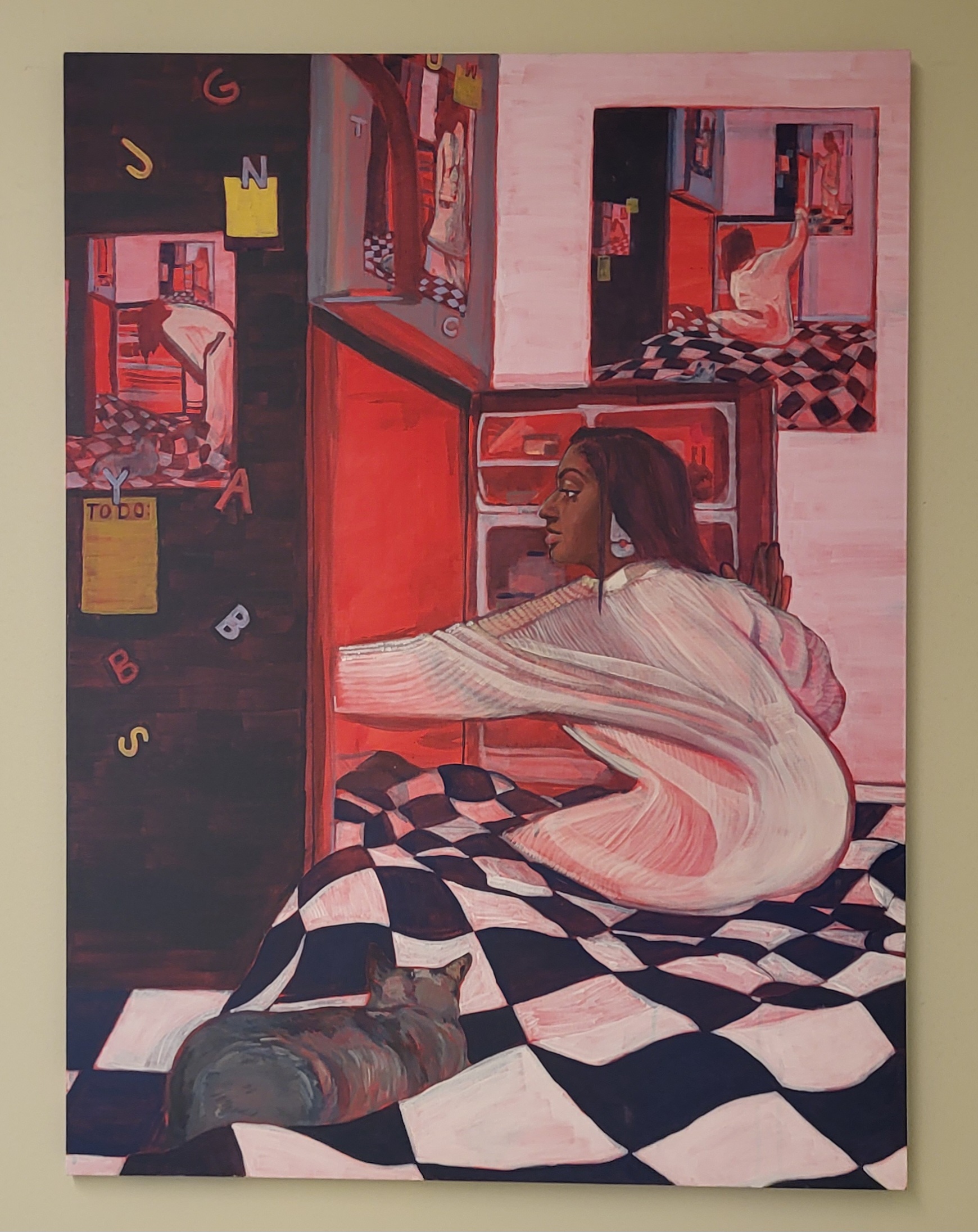 A woman in a white sweater is sitting on a black and white checkered floor. She is reaching into an open fridge lit with red light. A cat lies nearby. Mirrors and notes are visible, creating a reflective and introspective mood.