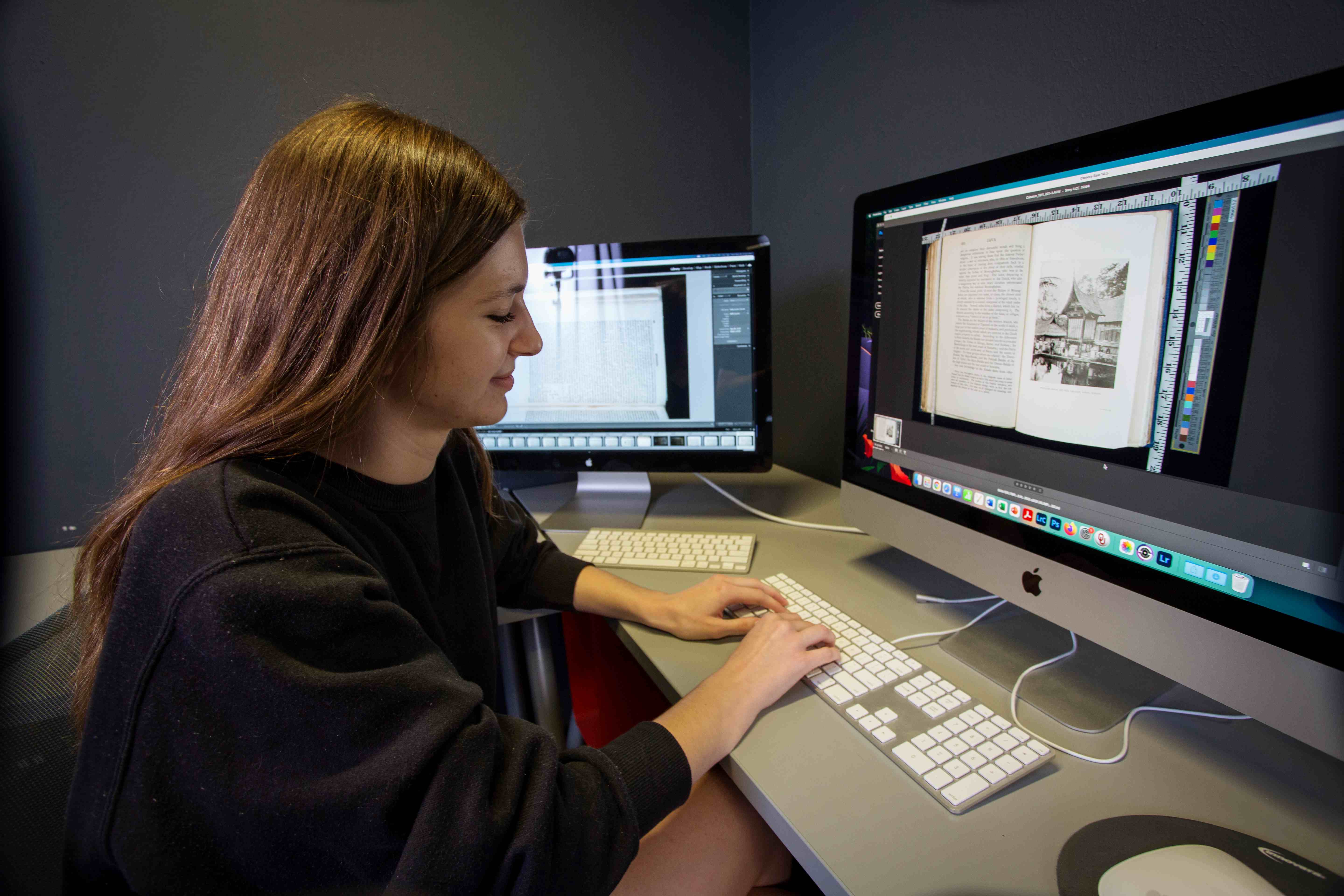 Student in the DigiLab working on a Mac computer describing a scanned book 