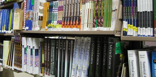 Bookshelf with neatly arranged textbooks of various subjects.
