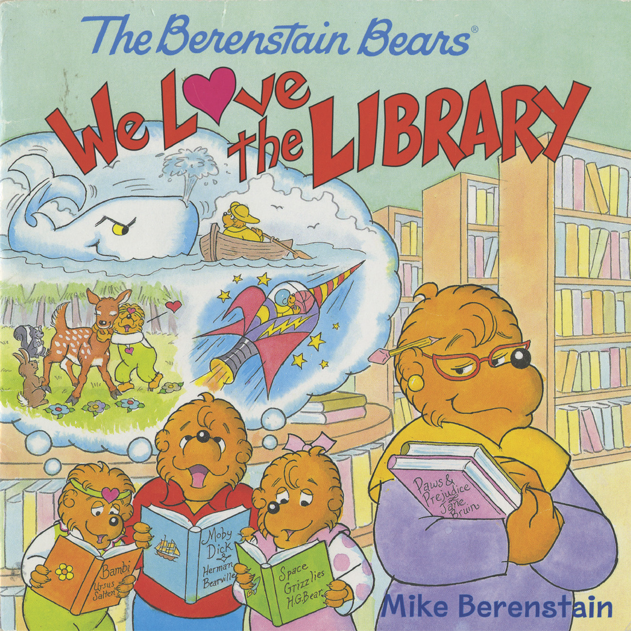 Book cover that reads "The Berenstain Bears, We Love the Library" by Mike Berenstain. The imagery features a drawing of a library with rows of shelves with books. Inside, Papa Bear and two bear cubs read books with excitement, while Momma Bear holds a stack of books while she looks on thoughtfully. A thought bubble shows story scenes of the books they are reading.